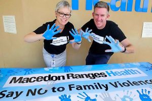 Show of blue hands on White Ribbon Day